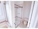 Bathroom featuring a glass-enclosed shower, tiled walls, and neutral color palette at 1431 Beacon Hill Dr, Highlands Ranch, CO 80126