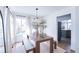 Cozy dining room with wood table, benches, and large windows providing ample natural light at 1431 Beacon Hill Dr, Highlands Ranch, CO 80126