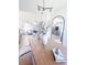 Bright dining room with modern chandelier, hardwood floors, and decorative flower arrangement at 1431 Beacon Hill Dr, Highlands Ranch, CO 80126
