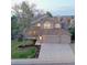 Charming two-story home with a three-car garage and well-manicured front lawn at 1431 Beacon Hill Dr, Highlands Ranch, CO 80126