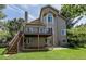 Spacious two-story home featuring a large deck, patio, and a well-manicured backyard at 1431 Beacon Hill Dr, Highlands Ranch, CO 80126