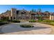 Grand home featuring a circular driveway and professionally landscaped yard at 1431 Beacon Hill Dr, Highlands Ranch, CO 80126