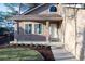 Inviting front porch with brick pillars and charming landscaping at 1431 Beacon Hill Dr, Highlands Ranch, CO 80126
