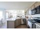Bright kitchen with stainless appliances, kitchen island, and open to the living space at 1431 Beacon Hill Dr, Highlands Ranch, CO 80126