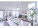 Spacious living room with large windows, high ceilings, a fireplace, and comfortable seating at 1431 Beacon Hill Dr, Highlands Ranch, CO 80126