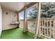 Relaxing covered balcony with swing, plush cushions, and artificial turf at 9944 E Carolina Cir # 201, Aurora, CO 80247