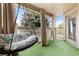 Relaxing covered balcony with swing, plush cushions, and artificial turf at 9944 E Carolina Cir # 201, Aurora, CO 80247