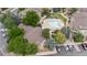 Aerial shot of a community pool and spa with surrounding lounge chairs, landscaping, and a nearby clubhouse at 9944 E Carolina Cir # 201, Aurora, CO 80247