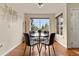 Bright dining area with hardwood floors, a modern table, and natural light from large windows at 9944 E Carolina Cir # 201, Aurora, CO 80247