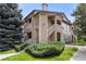 Exterior view of home featuring stone accents and lush landscaping at 9944 E Carolina Cir # 201, Aurora, CO 80247