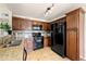 Well-equipped kitchen features granite counters and black appliances at 9944 E Carolina Cir # 201, Aurora, CO 80247