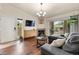 Cozy living room with a fireplace, wood floors, balcony access, and modern furnishings at 9944 E Carolina Cir # 201, Aurora, CO 80247