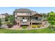 Landscaped backyard featuring an expansive deck with a hot tub and scenic views at 12665 S Robinson Ranch Ct, Parker, CO 80134