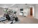 Finished basement featuring workout equipment, a small TV, and hallway to another area at 12665 S Robinson Ranch Ct, Parker, CO 80134