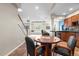 Basement area featuring a game table, wet bar with dark wood cabinetry, and stairs to the upper level at 12665 S Robinson Ranch Ct, Parker, CO 80134