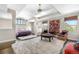Spacious primary bedroom features vaulted ceilings, a seating area, and an abundance of natural light at 12665 S Robinson Ranch Ct, Parker, CO 80134
