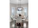 Dining area with round table, modern lighting and windows overlooking the front yard at 12665 S Robinson Ranch Ct, Parker, CO 80134