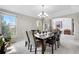 Formal dining room with modern lighting, neutral paint and carpet and large windows at 12665 S Robinson Ranch Ct, Parker, CO 80134