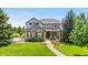 Charming two-story home boasting stone accents, lush landscaping and beautiful curb appeal at 12665 S Robinson Ranch Ct, Parker, CO 80134