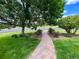 Beautiful walkway leading up to the home, with manicured lawn and mature trees at 12665 S Robinson Ranch Ct, Parker, CO 80134