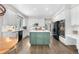 Eat-in kitchen features an island with a green base, white cabinetry, and stainless steel appliances at 12665 S Robinson Ranch Ct, Parker, CO 80134