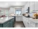 Well-lit kitchen features white cabinetry, a green island and stainless steel appliances at 12665 S Robinson Ranch Ct, Parker, CO 80134