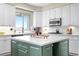 Kitchen features island with light green base, white quartz countertops and stainless steel appliances at 12665 S Robinson Ranch Ct, Parker, CO 80134