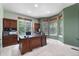 Home office with ample natural light from multiple windows and built-in shelving at 12665 S Robinson Ranch Ct, Parker, CO 80134