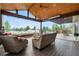 Enclosed patio featuring a fireplace, comfortable seating, and a scenic outdoor view at 12665 S Robinson Ranch Ct, Parker, CO 80134