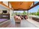 Spacious sunroom with wood ceiling, glass walls, comfortable seating, and outdoor views at 12665 S Robinson Ranch Ct, Parker, CO 80134