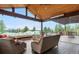 Inviting sunroom with comfortable seating, stone accents, and panoramic views of the surrounding landscape at 12665 S Robinson Ranch Ct, Parker, CO 80134