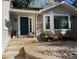 Charming home front entrance, with a brick facade, wood chairs, and a well-maintained walkway at 7744 S Oneida Ct, Centennial, CO 80112