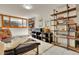 Basement living area with shelves, bright natural light, and neutral decor at 30122 Nancys Ln, Conifer, CO 80433