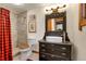 Modern bathroom featuring a vessel sink, tiled shower, and stylish fixtures with warm wood accents at 30122 Nancys Ln, Conifer, CO 80433