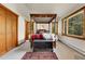 Bright, cozy bedroom with a four poster bed, natural light from the windows, and access to closet space at 30122 Nancys Ln, Conifer, CO 80433