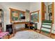 Home office with natural light, wood floors, neutral colors, and built-in shelving at 30122 Nancys Ln, Conifer, CO 80433