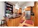 Spacious kitchen with wood cabinets, stainless appliances, black countertops, and hardwood floors at 30122 Nancys Ln, Conifer, CO 80433