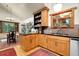 Bright kitchen with wood cabinets, black countertops, stainless steel appliances, and hardwood floors at 30122 Nancys Ln, Conifer, CO 80433