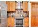 Updated kitchen featuring stainless steel oven, cooktop, and a modern vent hood at 30122 Nancys Ln, Conifer, CO 80433