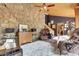Living room featuring a stone wall, hardwood floors, and an open layout perfect for entertaining at 30122 Nancys Ln, Conifer, CO 80433