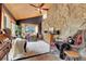 Charming living room with a stone accent wall, wood ceiling, and comfortable seating arrangement at 30122 Nancys Ln, Conifer, CO 80433