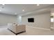 Bright basement area with a couch and a TV on the wall, great for relaxing and watching movies at 5271 Routt Ct, Arvada, CO 80002