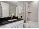 Bathroom with a large vanity, stylish fixtures, bathtub, and shower with sleek tile at 5271 Routt Ct, Arvada, CO 80002