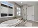 Luxurious bathroom featuring a soaking tub, glass-enclosed shower, and modern fixtures at 5271 Routt Ct, Arvada, CO 80002