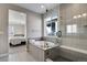 Sleek bathroom with a deep soaking tub, separate glass shower, and neutral tile at 5271 Routt Ct, Arvada, CO 80002