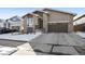 Home exterior with well-manicured lawn, a driveway, and a two-car garage in a suburban setting at 5271 Routt Ct, Arvada, CO 80002