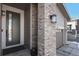 Home's front entrance featuring a stylish front door, and brick accents at 5271 Routt Ct, Arvada, CO 80002