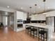 Gourmet kitchen features stainless steel appliances, black backsplash, and island with bar seating at 5271 Routt Ct, Arvada, CO 80002