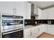Gourmet kitchen features stainless steel appliances, black backsplash, and modern built in microwave at 5271 Routt Ct, Arvada, CO 80002