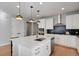 Gourmet kitchen features stainless steel appliances, black backsplash, and island with bar seating at 5271 Routt Ct, Arvada, CO 80002